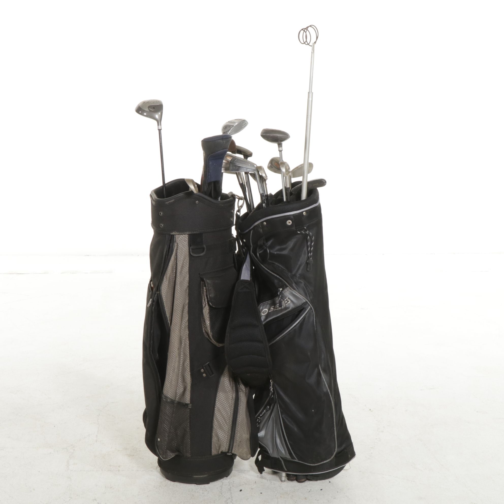 Two Golf Bags Including a Rival Titanium Reinforced 1-Driver and More Golf Clubs