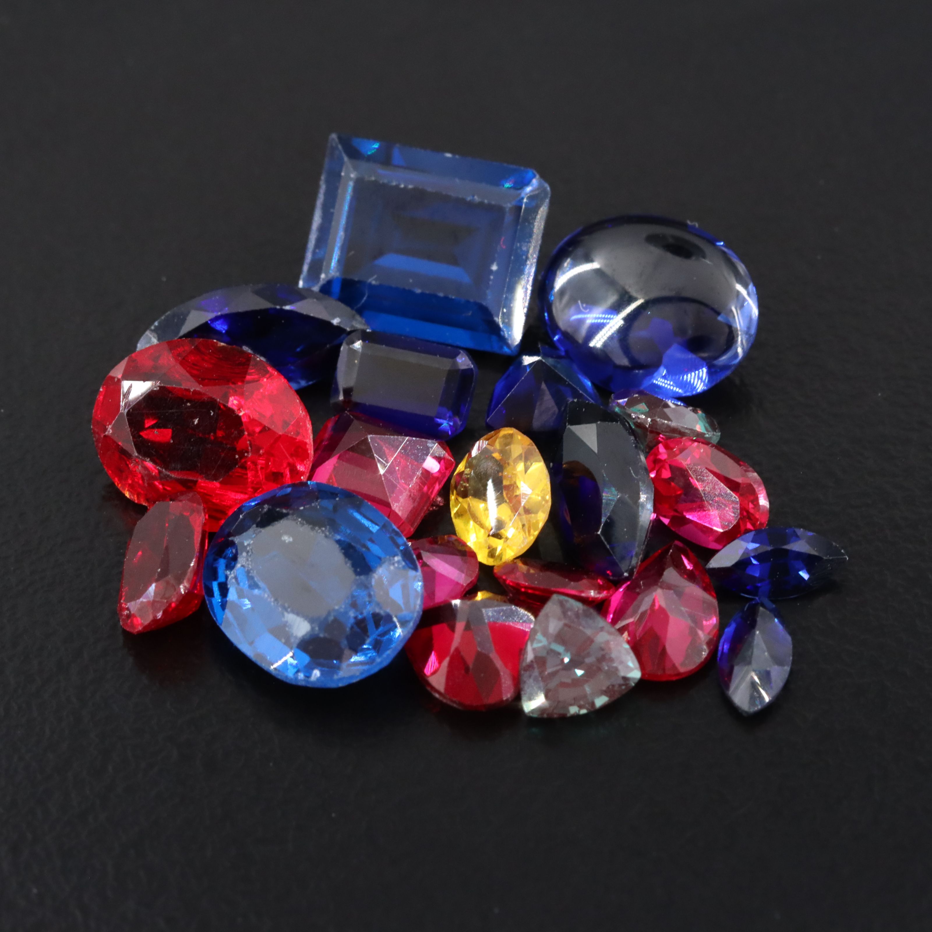 Loose 23.45 CTW Gemstone Lot Including Lab Grown Sapphire and Lab Grown Ruby