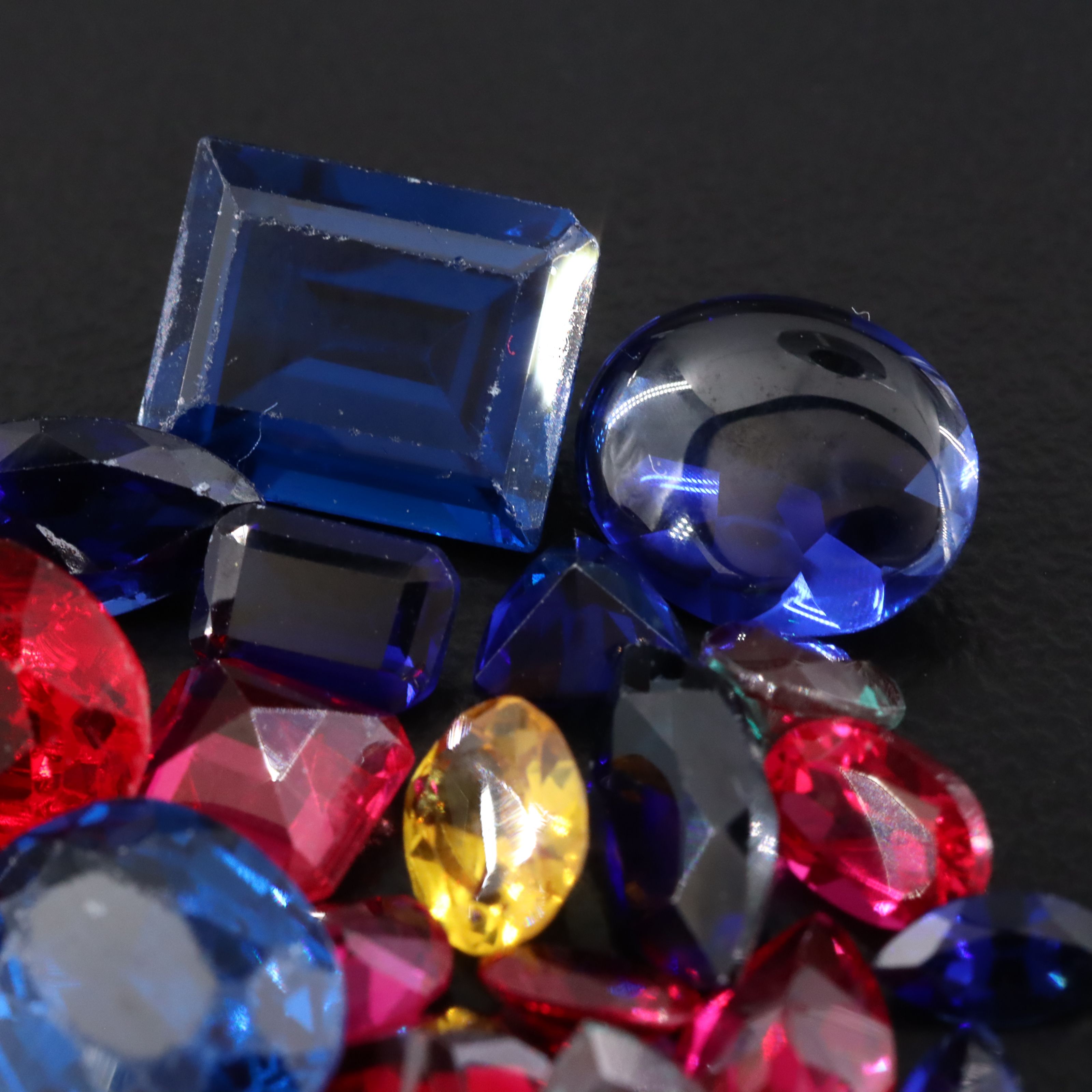 Loose 23.45 CTW Gemstone Lot Including Lab Grown Sapphire and Lab Grown Ruby