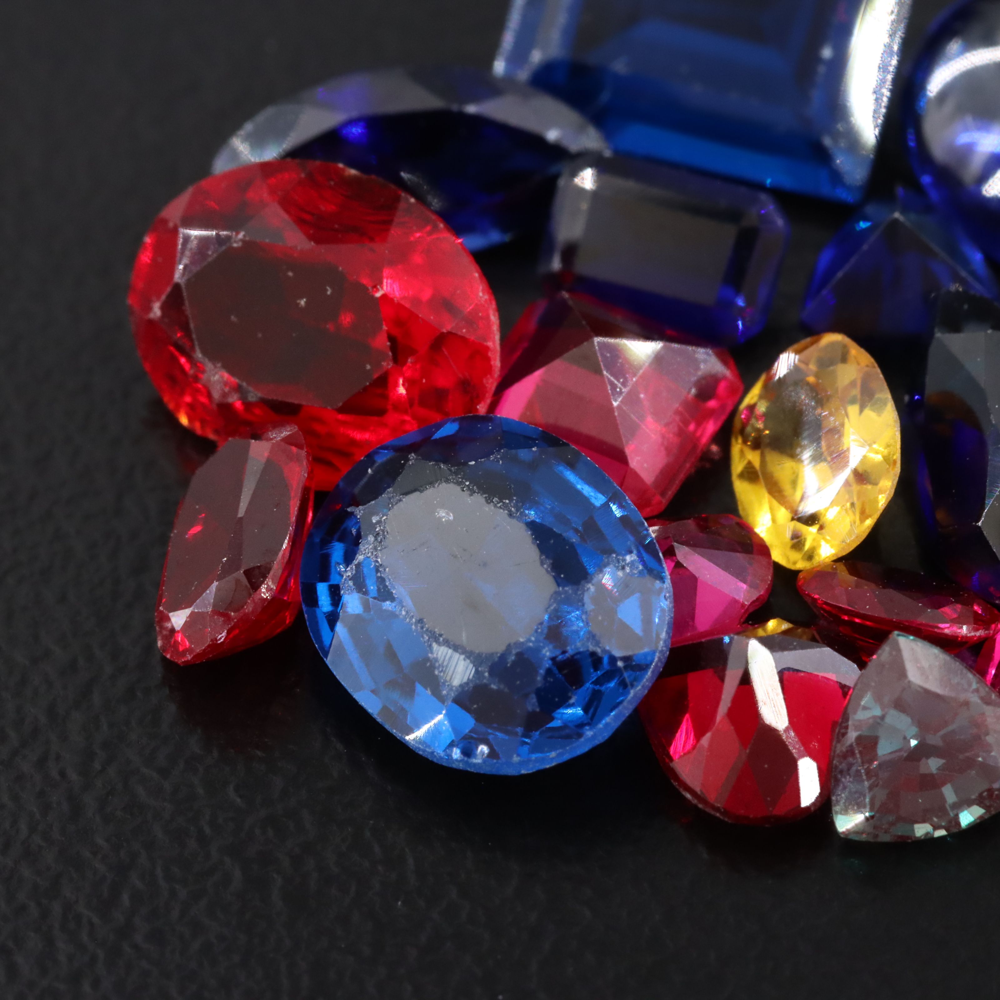 Loose 23.45 CTW Gemstone Lot Including Lab Grown Sapphire and Lab Grown Ruby